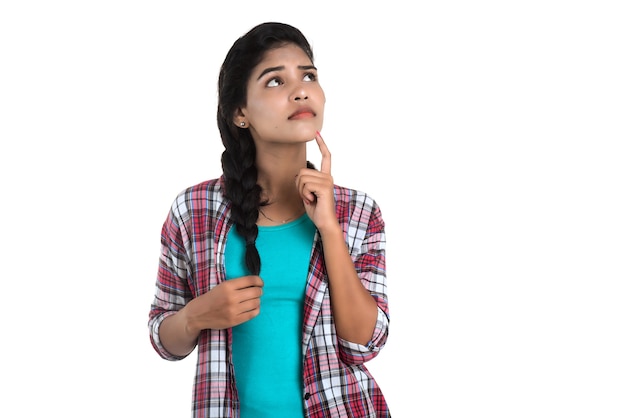 Indian girl thinking on a white background