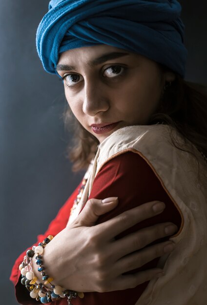 Indian girl in turban on a black background. 