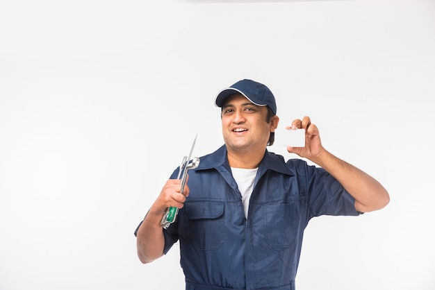 Indian happy auto mechanic in blue suit and cap