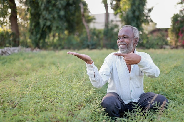 Indian happy farmer in a chickpea farm