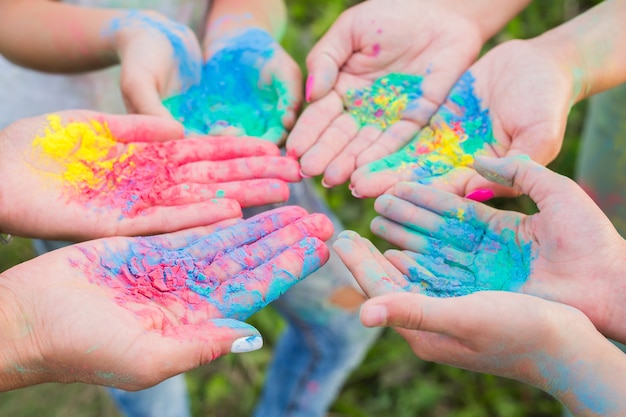 Indian holidays, fun and Holi festival concept - Female palms covered in different colors