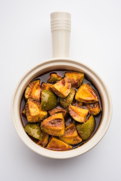 Indian Homemade Raw Mango Pickle or aam ka achar or Kairi Loncha in a bowl