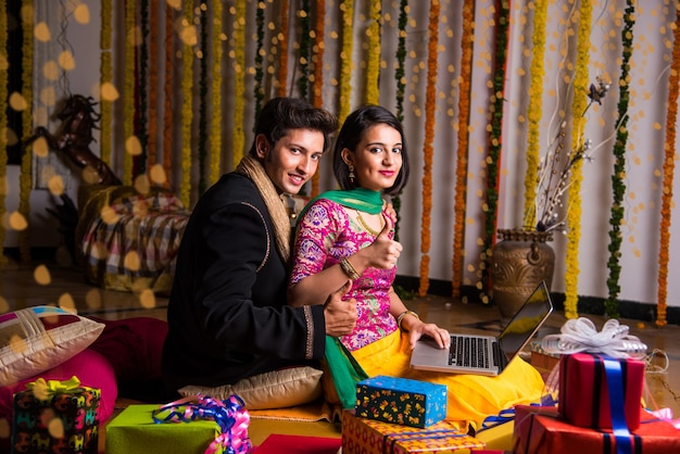 Indian husband tying or presenting necklace to his beautiful wife to celebrate anniversary of Diwali festival