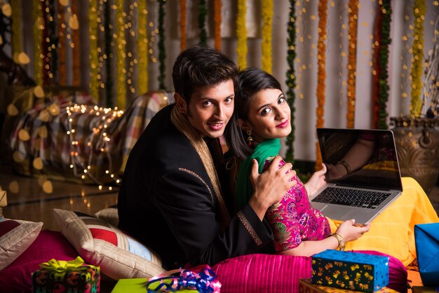 Indian husband tying or presenting necklace to his beautiful wife to celebrate anniversary of Diwali festival