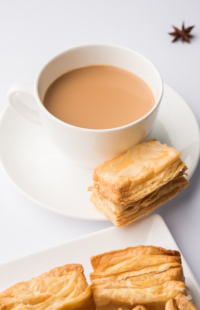 Indian khari or kharee or salty Puff Pastry Snacks, served with indian hot tea, selective focus texture