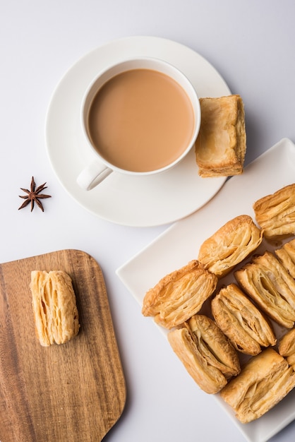 Indian khari or kharee or salty Puff Pastry Snacks, served with indian hot tea, selective focus texture