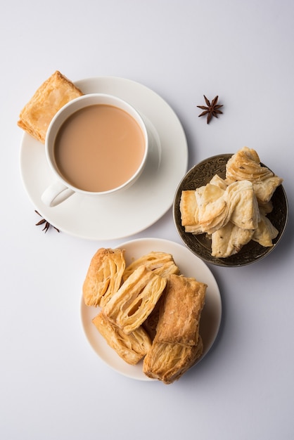 Indian khari or kharee or salty Puff Pastry Snacks, served with indian hot tea, selective focus texture