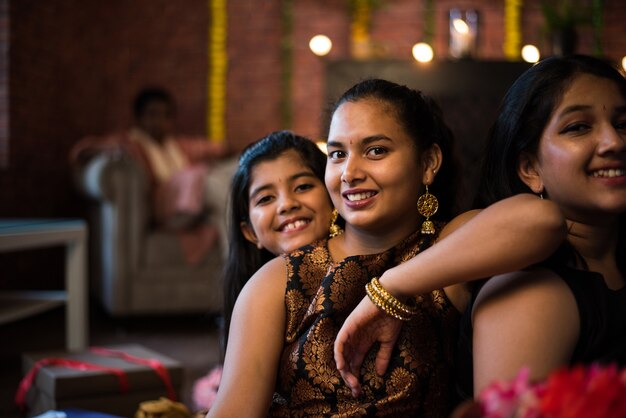 Photo indian kids celebrating diwali, deepawali, bhai dooj or rakhi or raksha bandhan with flower rangoli, gifts, diya