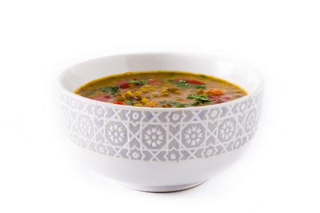 Indian lentil soup dal (dhal) in a bowl isolated on white. 