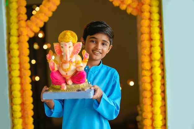 Indian little child celebrate lord ganesha festival.