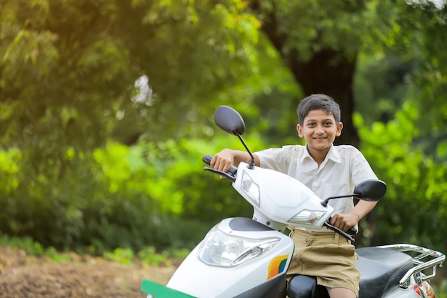 Indian little child riding motor bike