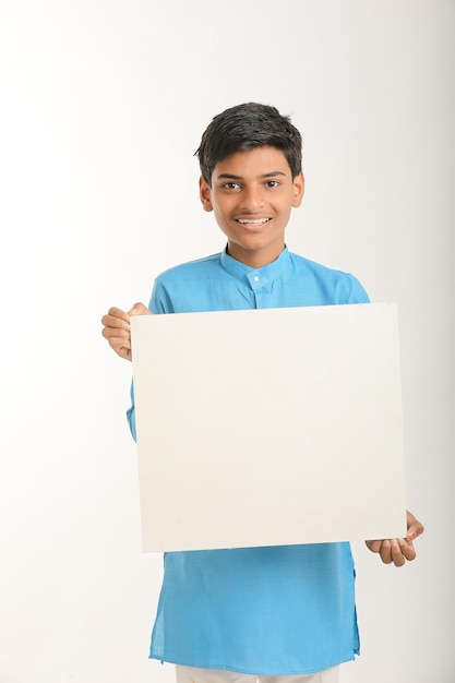 Indian little child in traditional wear and showing white board