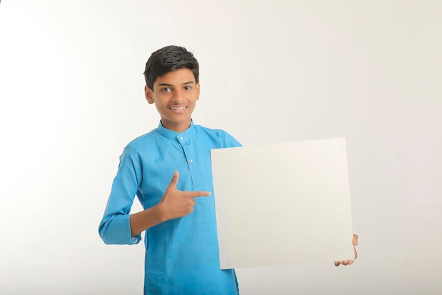 Indian little child in traditional wear and showing white board