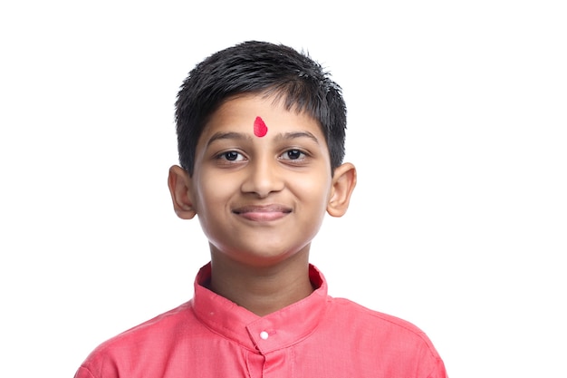Indian little child in traditional wear on white background.