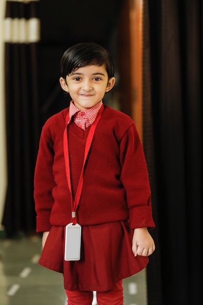 Indian little girl in school uniform and showing expression