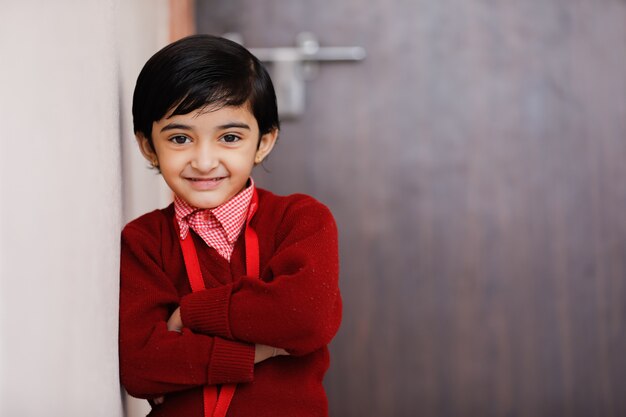 Indian little girl in school uniform and showing expression