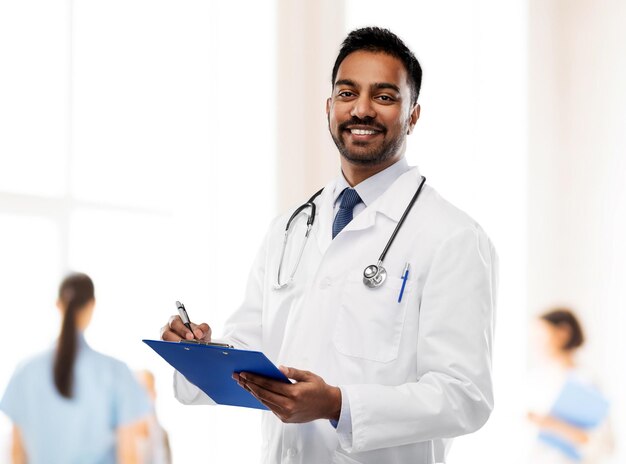 indian male doctor with clipboard and stethoscope