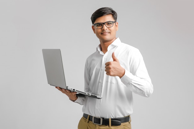 Indian man holding a computer