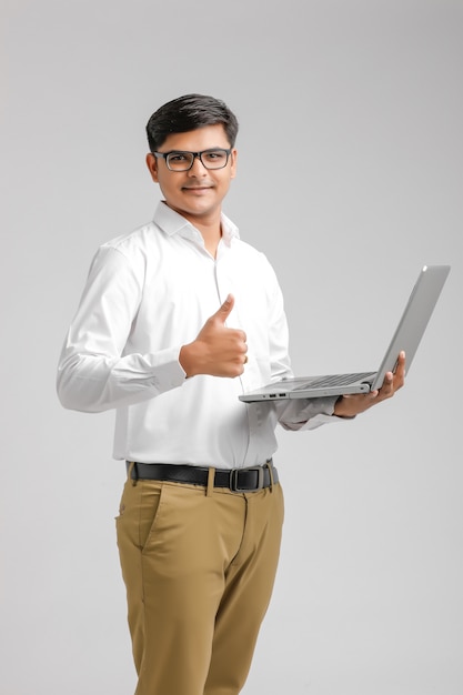 Indian man holding a computer