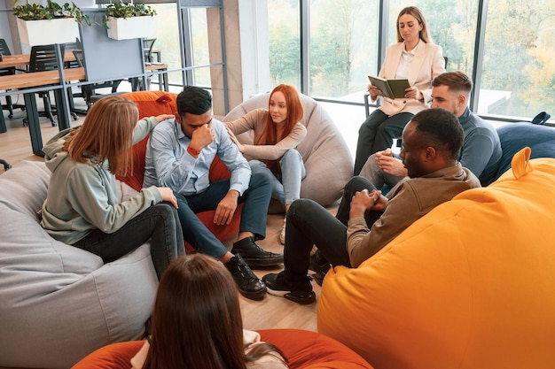 indian man is feeling bad group of people are having therapy meeting together