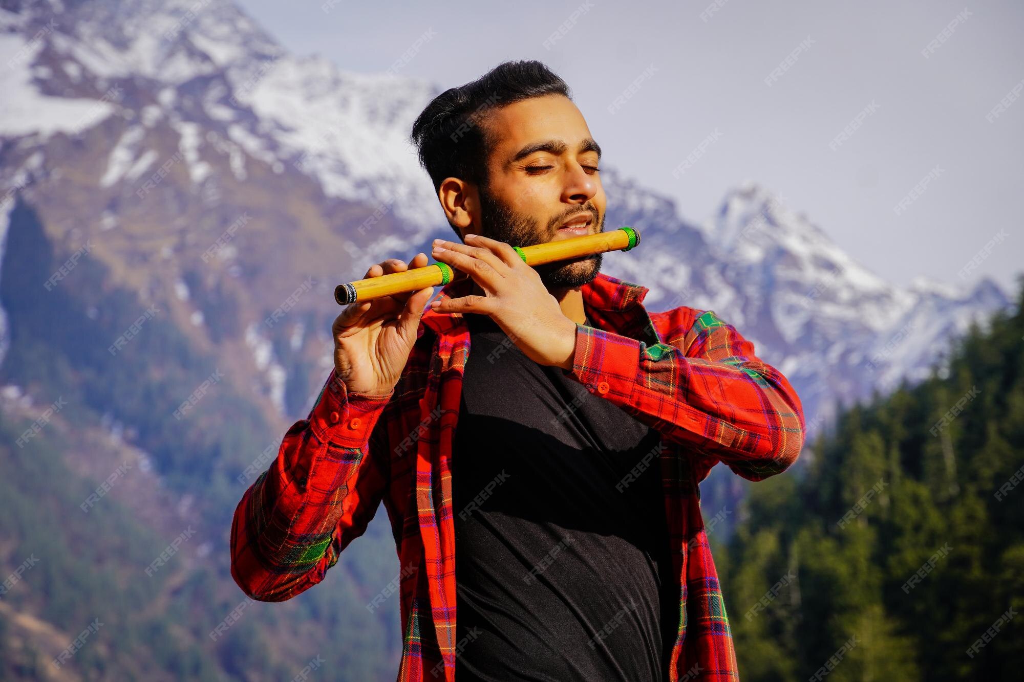 Premium Photo Indian man playing indian flute in mountains