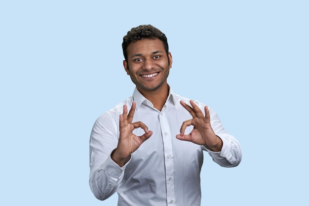 Indian man shows the okay gesture sign with both hands