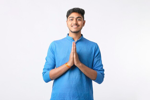 Indian man in tradition wear and giving expression on white background.