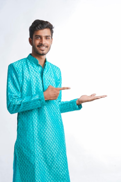 Indian man in tradition wear and giving expression on white background.