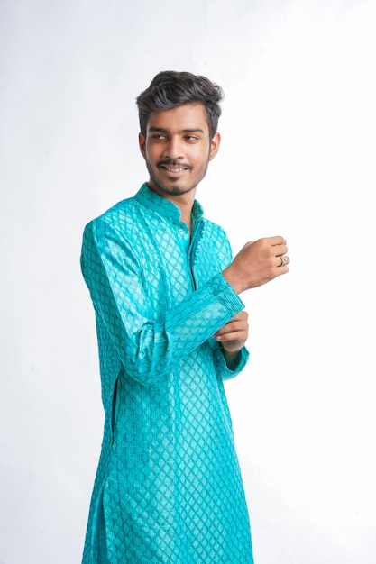 Indian man in tradition wear and giving expression on white background.