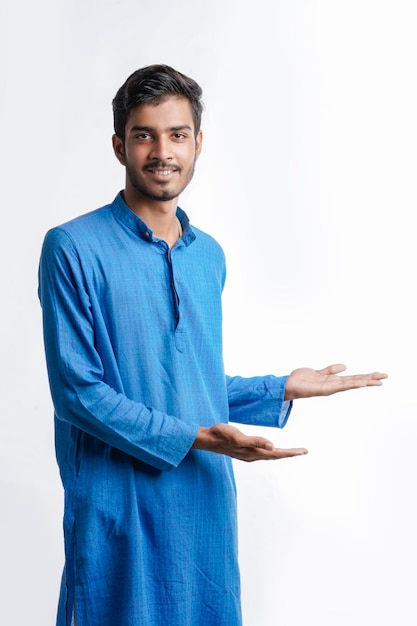 Indian man in tradition wear and giving expression on white background.