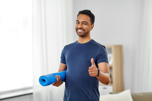 indian man with fitness tracker showing thumbs up