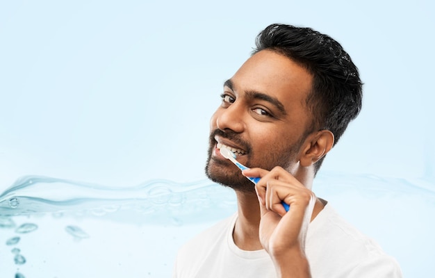 indian man with toothbrush cleaning teeth