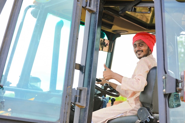 Indian man working with heavy equipment vehicle at construction site.