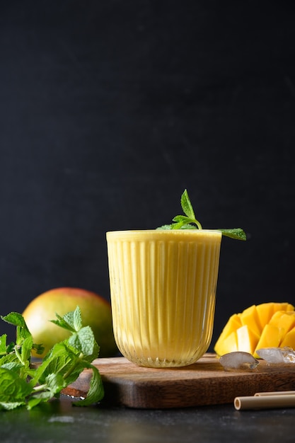 Photo indian mango or turmeric lassi on black background