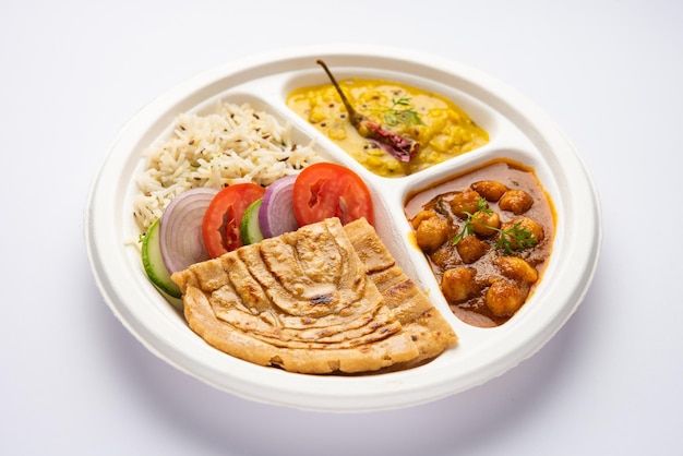 Photo indian mini meal parcel platter combo thali with chole masala roti dal tarka jeera rice salad