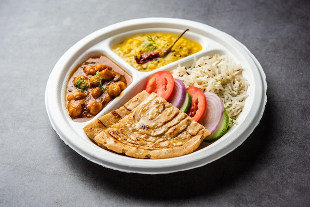 Indian mini meal parcel platter combo thali with chole Masala roti dal tarka jeera rice salad