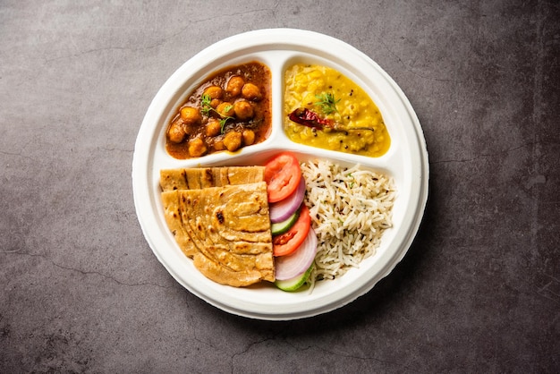 Indian mini meal parcel platter combo thali with chole Masala roti dal tarka jeera rice salad