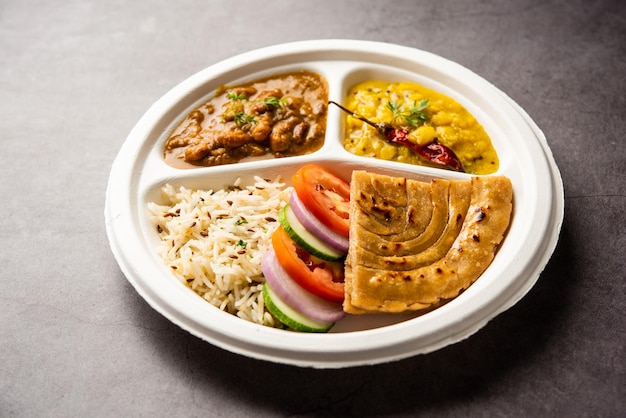 Indian mini meal parcel platter combo thali with Rajma Masala roti dal tadka jeera rice salad