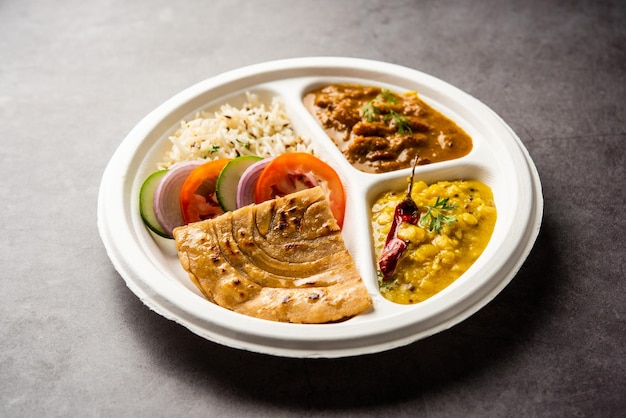 Indian mini meal parcel platter combo thali with Rajma Masala roti dal tadka jeera rice salad