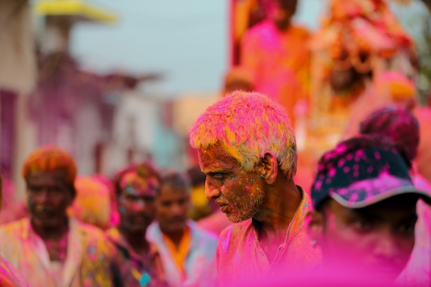 Indian Old Man playing with colors in Holi Festival Free Photo