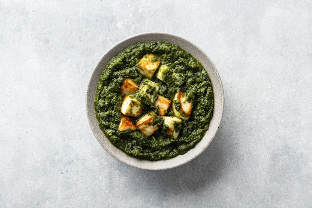 indian palak paneer on concrete surface top view