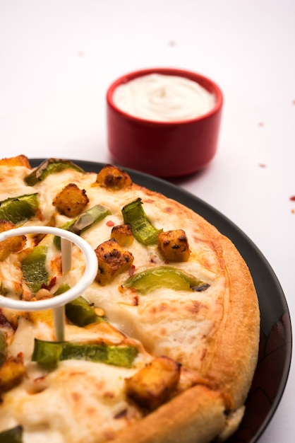 Indian Paneer Pizza with fresh cottage Cheese cubes and white sauce