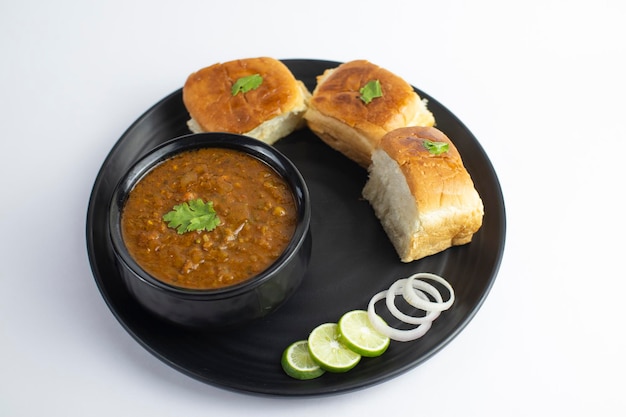 Indian Pav bhaji, fast food dish from mumbai, vegetable curry served with a soft bread roll