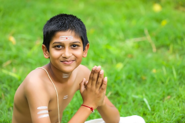 The indian priest child doing meditation