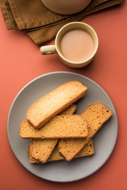 Indian punjabi or Delhi bread or tutti fruitti flavoured toast, served with indian hot tea, selective focus texture