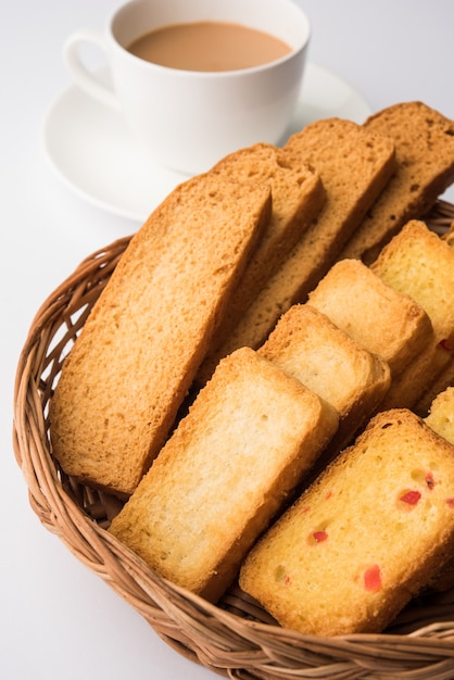 Indian punjabi or Delhi bread or tutti fruitti flavoured toast, served with indian hot tea, selective focus texture