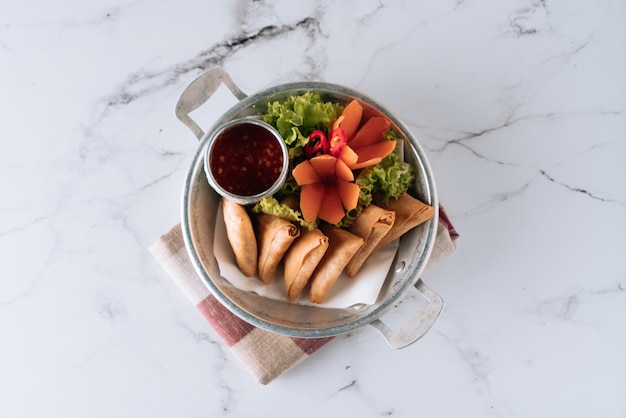 Indian ramzan cuisine Spicy Vegetable curry samosa with chili sauce in a dish isolated on mat top view on grey marble background