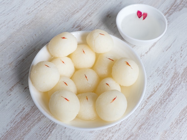 Indian Rasgulla dessert. Sweet served in a bowl, top view.