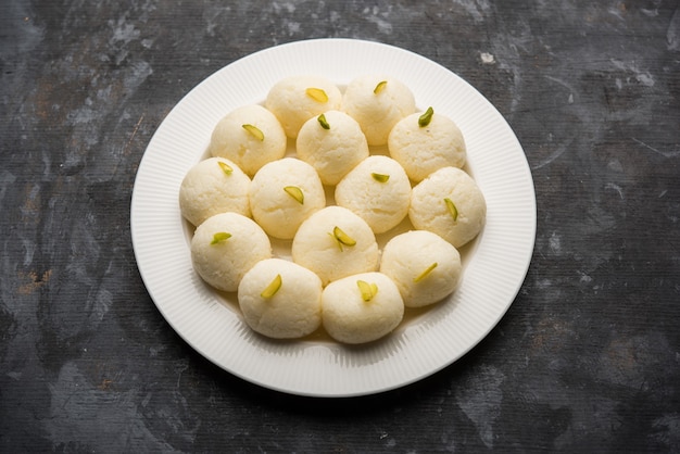 Indian Rasgulla or Rosogulla dessert sweet served in a bowl. selective focus