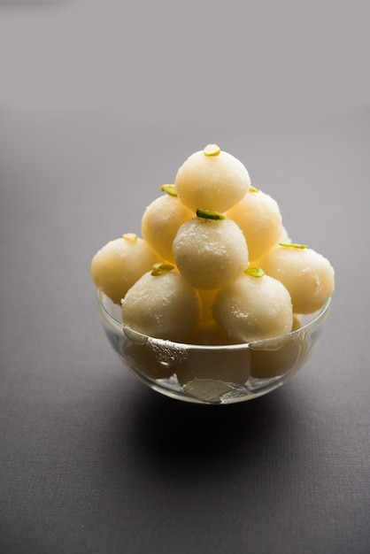 Indian Rasgulla or Rosogulla dessert sweet served in a bowl. selective focus